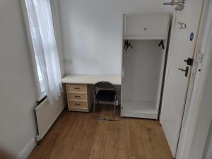 a room with a desk and a chair next to a door at Cristabel Guest House in Clacton-on-Sea +3 photos
