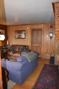 a living room with a blue couch in a room at The Loan in Achiltibuie