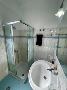 a bathroom with a glass shower and a sink at VIOLA Seaside Villa in Ksamil +41 photos