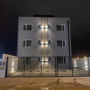a building with lights on the side of it at night at Amelie 2 in General Roca