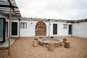 a courtyard with a stone bench and a stone wall at Landskap in Robertson