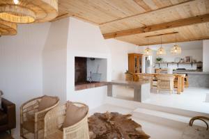 a kitchen and living room with white walls and wooden ceilings at Landskap in Robertson