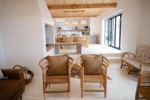 a living room with wicker chairs and a table at Landskap in Robertson +9 photos