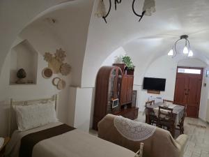 a bedroom with a bed and a table and a desk at Nonno Pasquale house in Locorotondo