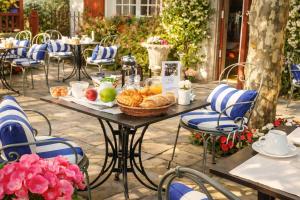 a table with a basket of bread and fruit on it at Hotel Villa Catarie in Guéthary