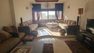 a living room with a couch and a table at Apartment Hamria Meknes in Meknès