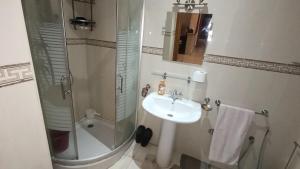 a bathroom with a sink and a shower at Apartment Hamria Meknes in Meknès +12 photos