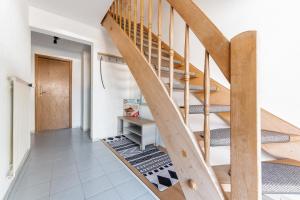 a wooden staircase in a room with a hallway at Haus MALEA by Wohn-Zeit - über 200 Betten im Umkreis von 87700 Memmingen in Fellheim