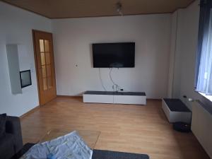 a living room with a flat screen tv on the wall at Unterkunft mit Kindernische in Ober-Mörlen