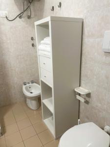 a white bathroom with a toilet and a sink at Tinetto Brezza di mare in Deiva Marina