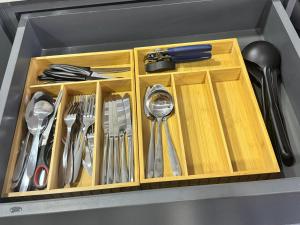 a wooden drawer with utensils in a sink at Riverside Apartments in Jacó +45 photos