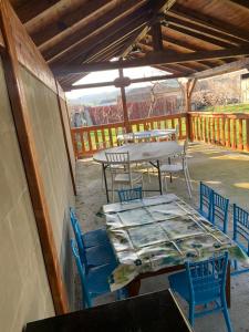 an outdoor patio with tables and chairs and a table and chairs at Casa Gheorghe in Balabancea