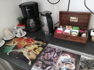 a table with a coffee maker and a tray of food at Yuca in Vallauris