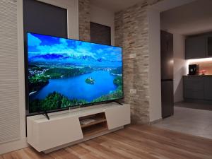 a large flat screen tv in a living room at Apartment Andreja Bled in Bled