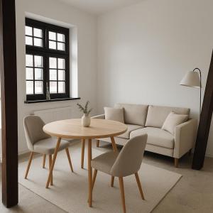 a living room with a table and a couch at Gościniec u Bernackich in Smołdzino