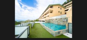 a swimming pool on the balcony of a building at Zen escape-ocean view Papeete in Papeete