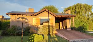 a small yellow house with a roof at Cabaña Lemunko in Sierra de la Ventana