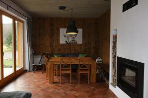 a dining room with a wooden table and chairs at Willa Potoczówka in Rzyki +23 photos