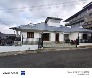 a white house with a metal roof at Vagamon Hill Chimes in Vagamon