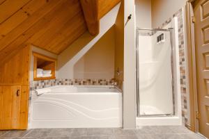 a bath tub in a bathroom with a shower at Overlander Mountain Lodge in Brule Mines +163 photos
