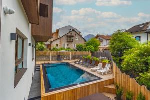 a swimming pool in the backyard of a house at Garni Residence Alnö - Adults Only Dolomites in San Vigilio Di Marebbe