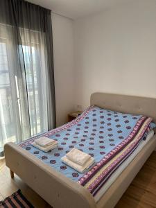 a bed with two towels on it in a room at Una La Unica in Bihać