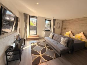 a living room with a couch and a large window at Das Waldhaus in Forbach