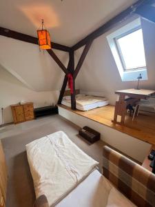 a attic room with a bed and a table at Prázdninový dům Šternberk in Šternberk