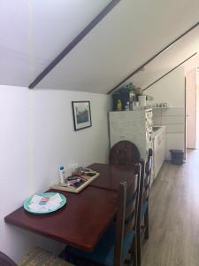 a dining room with a wooden table and chairs at Hostel FM in Mostar