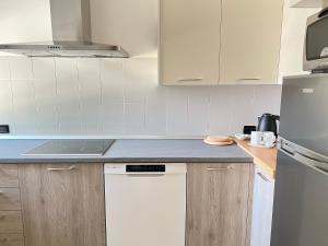 a kitchen with white cabinets and a white dishwasher at Casa Camilla in Lido di Fermo +7 photos