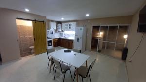 a kitchen with a table and chairs and a refrigerator at Alojamiento Hugo in Río Segundo