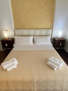 a bedroom with a bed with two towels on it at Sparano 51 in Bari