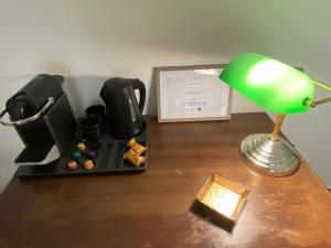 a desk with a lamp and a cup of coffee and a candle at Sparano 51 in Bari