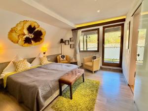 a bedroom with a large bed and a living room at Das Waldhaus in Forbach +40 photos