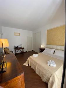 a bedroom with a bed with two white towels on it at Sparano 51 in Bari