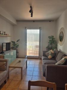 a living room with a couch and a coffee table at 1 Duplex Las Terrazas Cubes in Vélez de Benaudalla