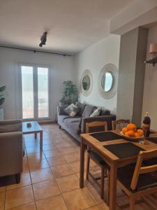 a living room with a couch and a table at 1 Duplex Las Terrazas Cubes in Vélez de Benaudalla