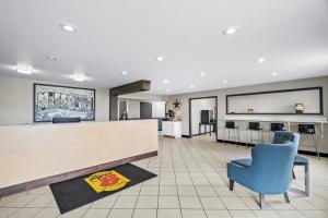 a lobby with a counter and chairs and a bar at Super 8 by Wyndham Farmington in Farmington +47 photos