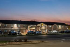 a gas station with cars parked in front of it at Super 8 by Wyndham Farmington in Farmington