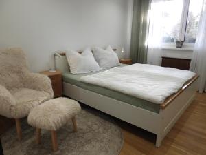 a bedroom with a bed and a chair at Casa Diego in Spielberg +58 photos