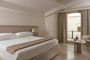 Кровать или кровати в номере Relais Histò San Pietro Sul Mar Piccolo