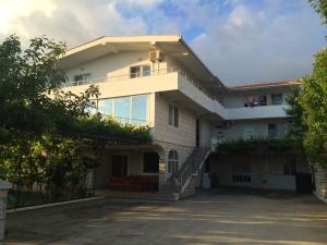 a large white house with a driveway at Guest House Lalic in Bar