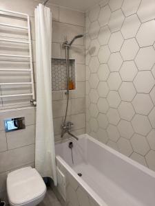 a bathroom with a tub and a toilet and a shower at Apartment near the sea-Sigulda street in Liepāja +28 photos
