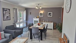 a dining room and kitchen with a table and chairs at Pokoje U Rycha in Augustów