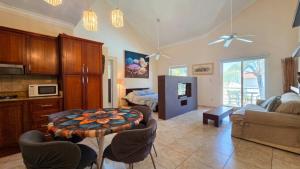 a living room with a table and some chairs at Ocean Dream Beachfront Studio with Balcony in Cabarete