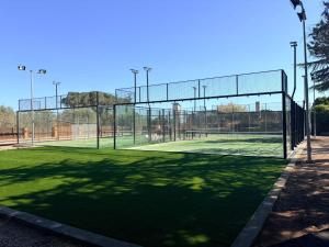 a tennis court with a net on a tennis court at Felix Hotel in Valls +150 photos