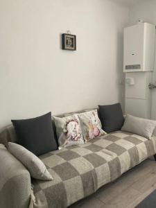 a couch with pillows on it in a living room at Refugiul Castelului in Hunedoara