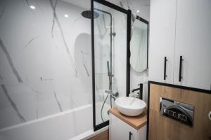a bathroom with a sink and a shower at ApartCieszyn - Apartament Liburnia in Cieszyn +14 photos