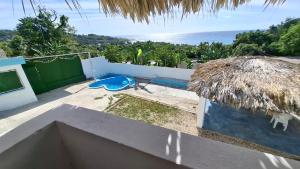 a view of the ocean from the balcony of a house at Villa hotel Gabi Larimar in La Ciénaga +17 photos