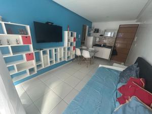 a living room with a bed and a kitchen at Terrazzas Flat in João Pessoa